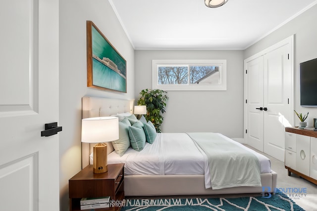 bedroom featuring a closet and crown molding