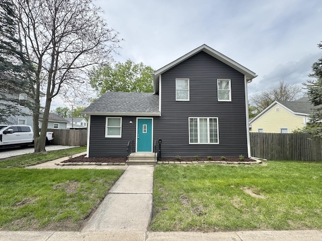614 E Baltimore St, Wilmington, IL 60481 - traditional-style house featuring roof with shingles, a front lawn, and fence