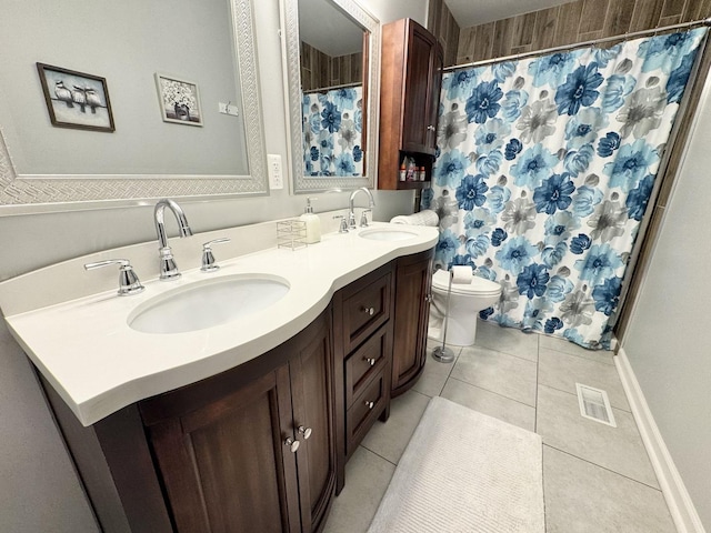 614 E Baltimore St, Wilmington, IL 60481 - full bathroom with double vanity, tile patterned floors, visible vents, and a sink