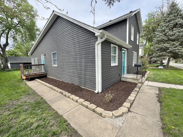 614 E Baltimore St, Wilmington, IL 60481 - view of side of property featuring a yard and a wooden deck
