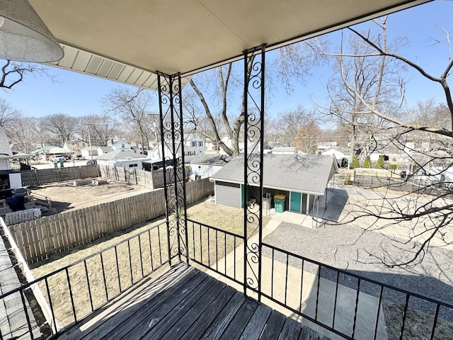 614 E Baltimore St, Wilmington, IL 60481 - wooden terrace featuring a patio area, an outbuilding, a residential view, and a fenced backyard