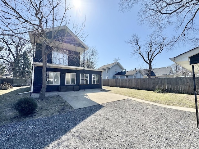 614 E Baltimore St, Wilmington, IL 60481 - back of property featuring a patio, a residential view, and a fenced backyard