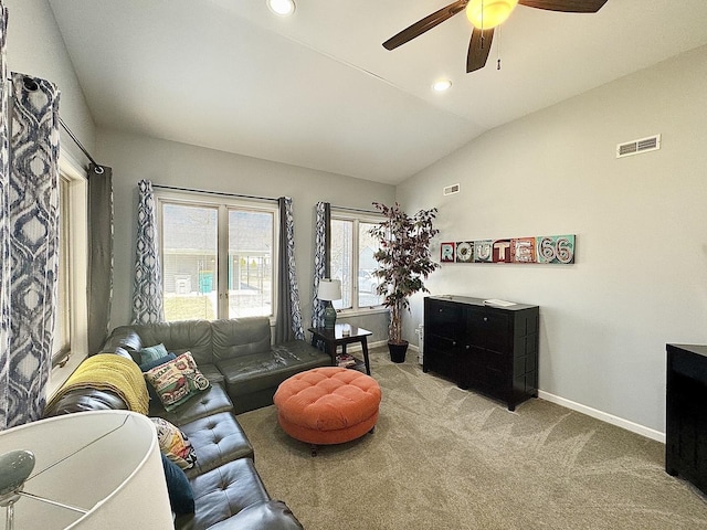 614 E Baltimore St, Wilmington, IL 60481 - living area with light colored carpet, visible vents, vaulted ceiling, ceiling fan, and baseboards