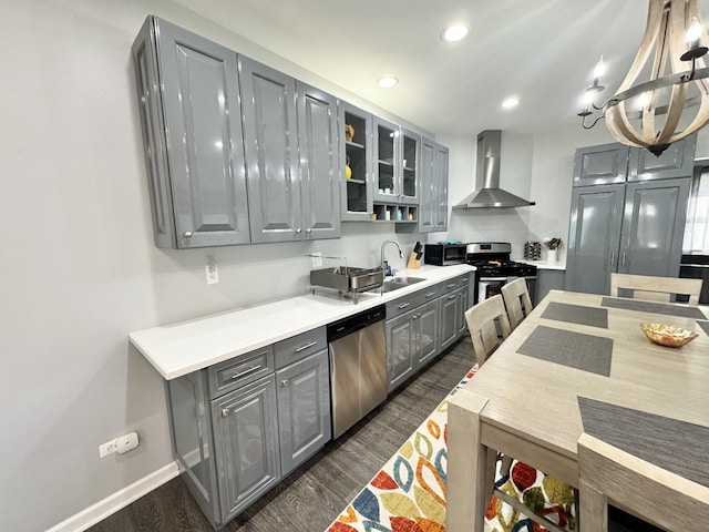 614 E Baltimore St, Wilmington, IL 60481 - kitchen featuring a sink, stainless steel appliances, wall chimney range hood, gray cabinets, and dark wood-style floors
