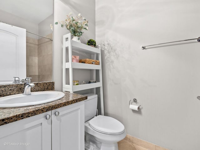 bathroom with vanity, toilet, and tile patterned floors