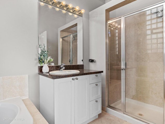 bathroom featuring tile patterned floors, vanity, and a shower with door