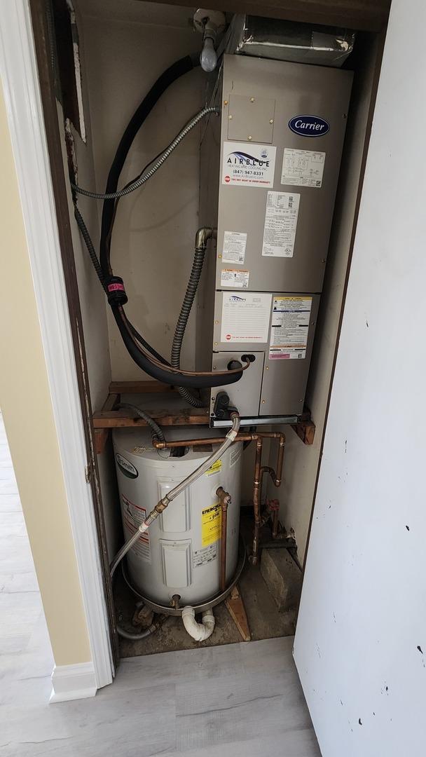 15 Piper Ln Unit 102, Prospect Heights, IL 60070 - washroom with concrete block wall, independent washer and dryer, and baseboard heating