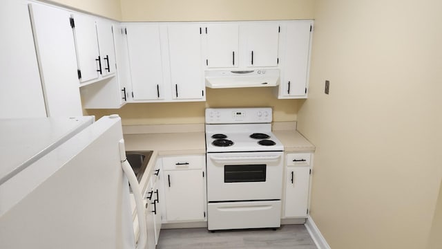 kitchen featuring electric range, light countertops, under cabinet range hood, and white cabinetry