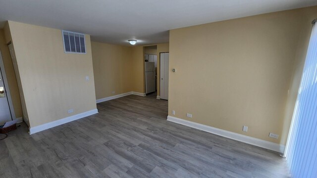 15 Piper Ln Unit 102, Prospect Heights, IL 60070 - unfurnished bedroom featuring wood finished floors, baseboards, and ensuite bathroom