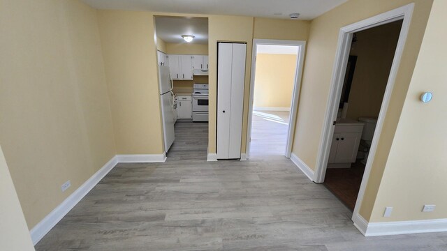 15 Piper Ln Unit 102, Prospect Heights, IL 60070 - kitchen featuring extractor fan, electric range, fridge, light countertops, and white cabinetry