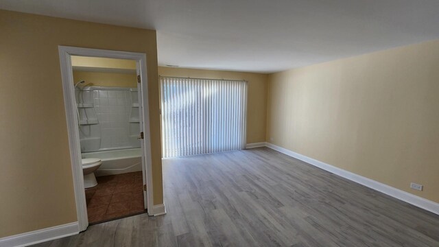 15 Piper Ln Unit 102, Prospect Heights, IL 60070 - unfurnished room featuring baseboards and dark wood-type flooring