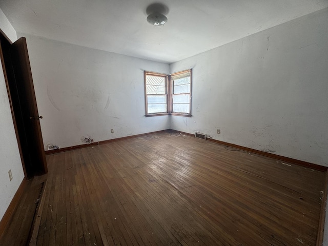 empty room featuring dark wood-type flooring