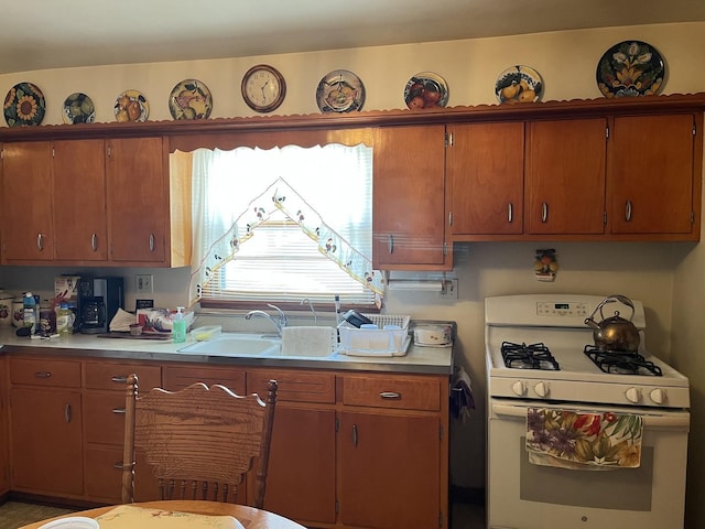 kitchen with sink and white range with gas cooktop