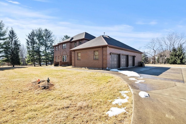 view of home's exterior featuring a garage, concrete driveway, brick siding, and a lawn