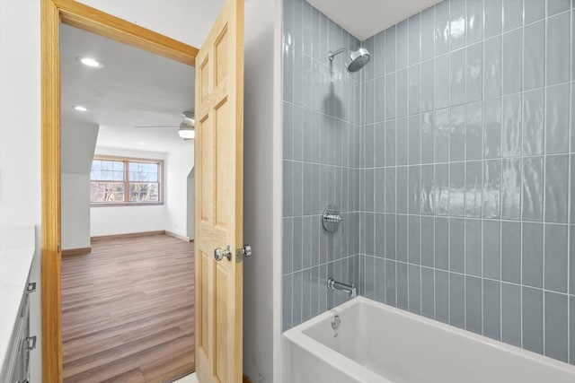 full bath featuring recessed lighting, shower / bath combination, wood finished floors, vanity, and baseboards