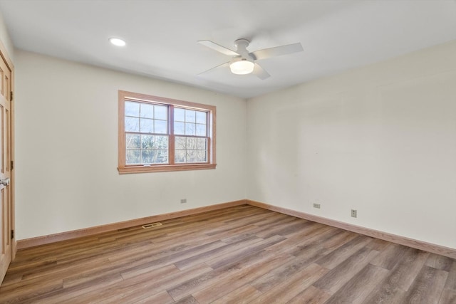 unfurnished room with light wood finished floors, ceiling fan, and baseboards