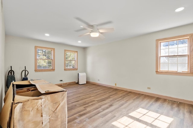 office space featuring light wood-type flooring, baseboards, a ceiling fan, and recessed lighting