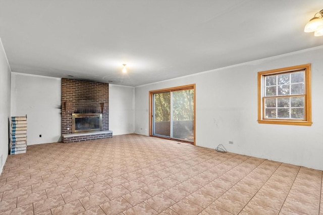 unfurnished living room with ornamental molding and a brick fireplace