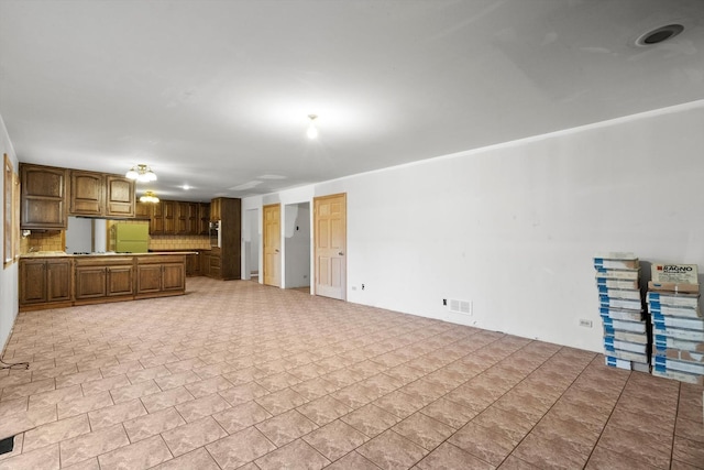 unfurnished living room featuring visible vents