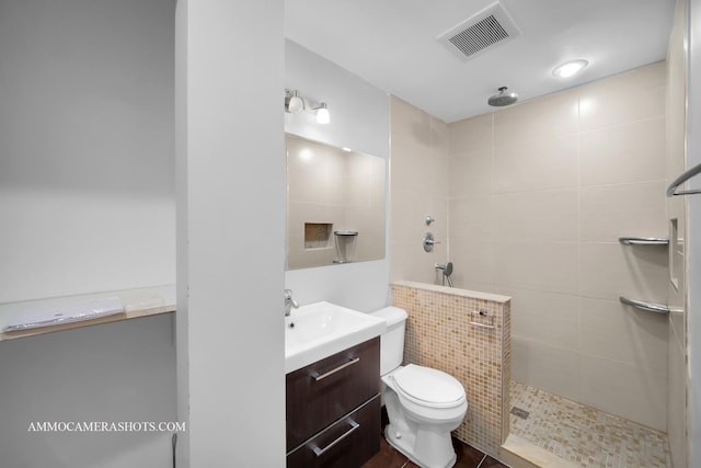 full bathroom featuring visible vents, vanity, toilet, and walk in shower