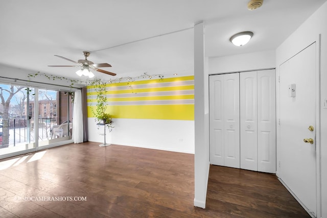 spare room featuring wood finished floors and a ceiling fan