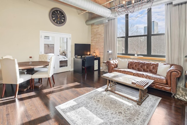 living room featuring a high ceiling, french doors, and dark hardwood / wood-style flooring