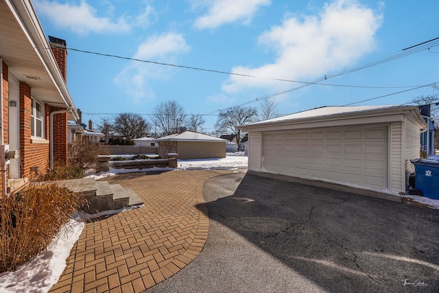 detached garage featuring fence