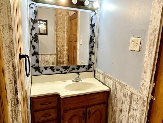 bathroom featuring a wainscoted wall and vanity