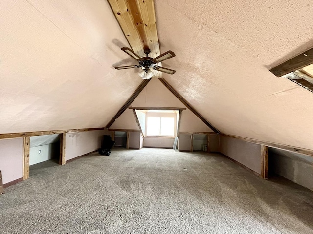 additional living space with carpet, vaulted ceiling, and a textured ceiling