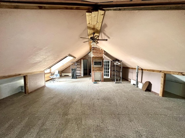 additional living space featuring a ceiling fan, carpet flooring, vaulted ceiling, and a textured ceiling