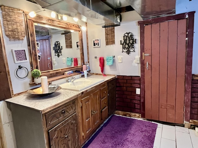 bathroom with tile patterned flooring and vanity