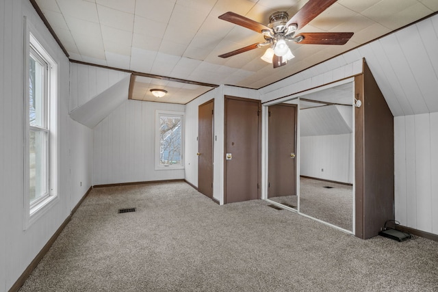 bonus room featuring a ceiling fan, carpet, visible vents, and vaulted ceiling