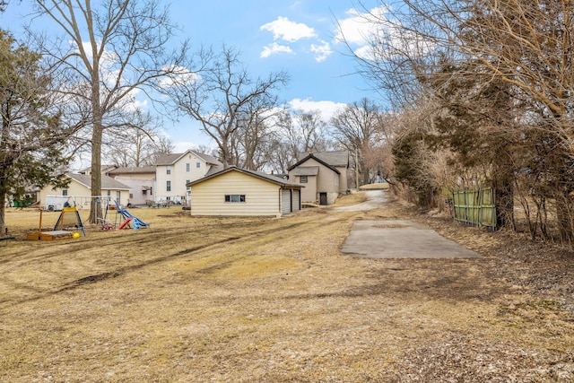 view of yard featuring a playground and fence