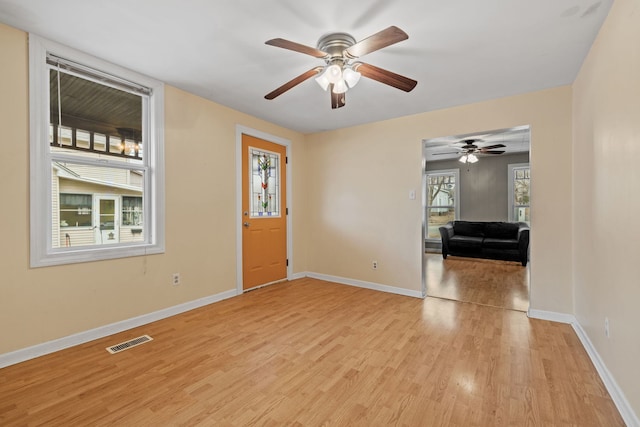 entryway featuring light wood-type flooring, baseboards, and visible vents