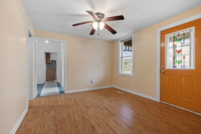 entrance foyer with light wood finished floors, ceiling fan, visible vents, and baseboards