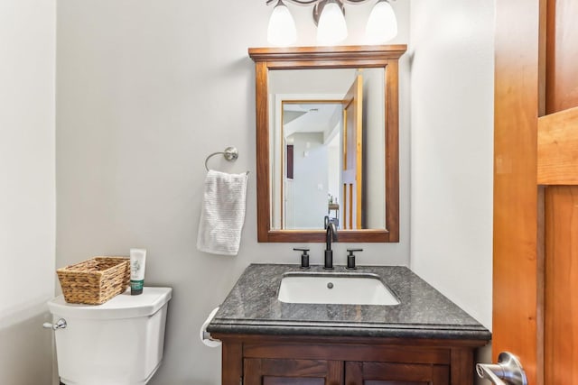 half bath featuring toilet and vanity