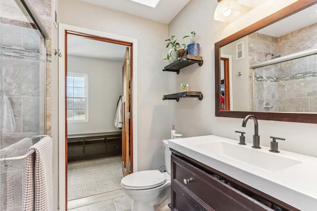 full bath with tile patterned flooring, visible vents, a shower stall, toilet, and vanity