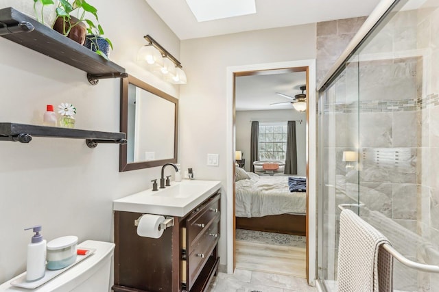 bathroom with a stall shower, ensuite bath, a skylight, and vanity