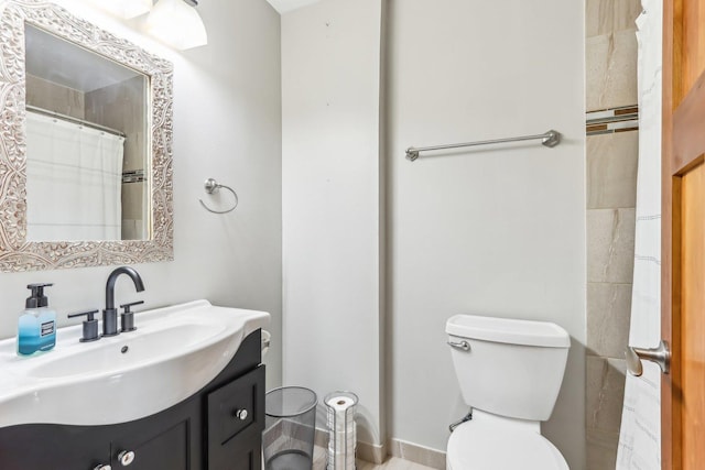 bathroom with toilet and vanity