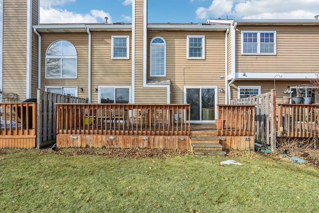 rear view of property featuring a yard, a chimney, and a wooden deck