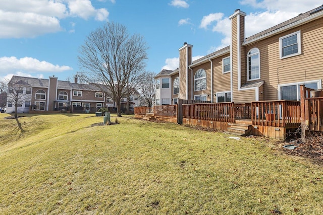 view of yard featuring a residential view and a deck