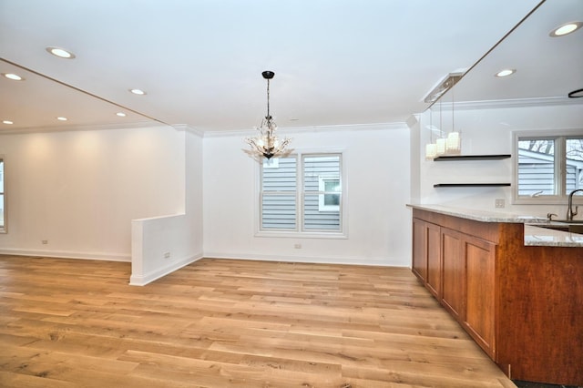 unfurnished dining area with crown molding, a notable chandelier, recessed lighting, and light wood finished floors