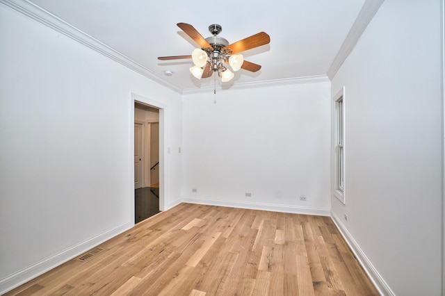 unfurnished bedroom featuring visible vents, light wood-style flooring, baseboards, and ornamental molding