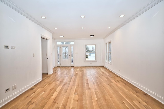 unfurnished living room featuring crown molding, baseboards, visible vents, and light wood finished floors