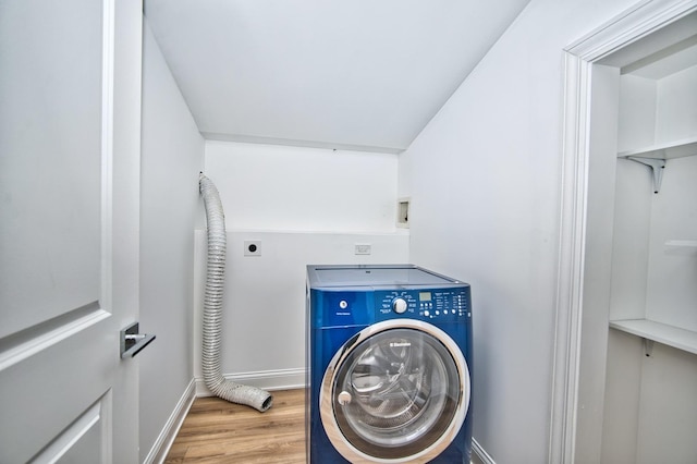 laundry room with washer / dryer, wood finished floors, baseboards, and laundry area