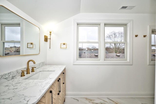 bathroom with vanity, visible vents, marble finish floor, and baseboards