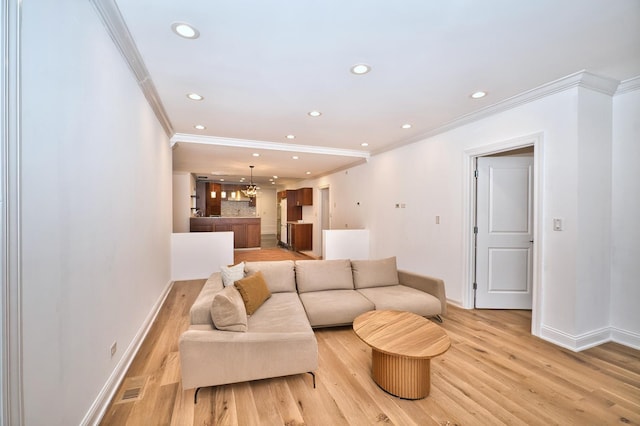 living area featuring recessed lighting, light wood-type flooring, baseboards, and an inviting chandelier