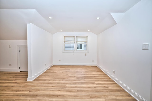 bonus room featuring recessed lighting, light wood-type flooring, baseboards, and vaulted ceiling