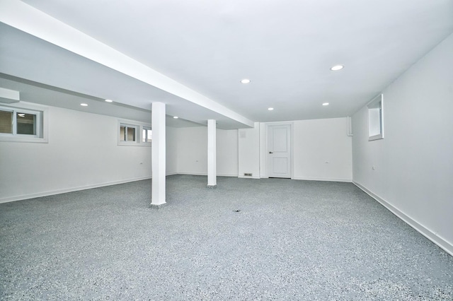 basement featuring recessed lighting, baseboards, and plenty of natural light