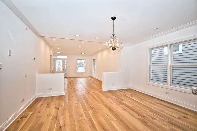 interior space with a chandelier, light wood-type flooring, baseboards, and ornamental molding